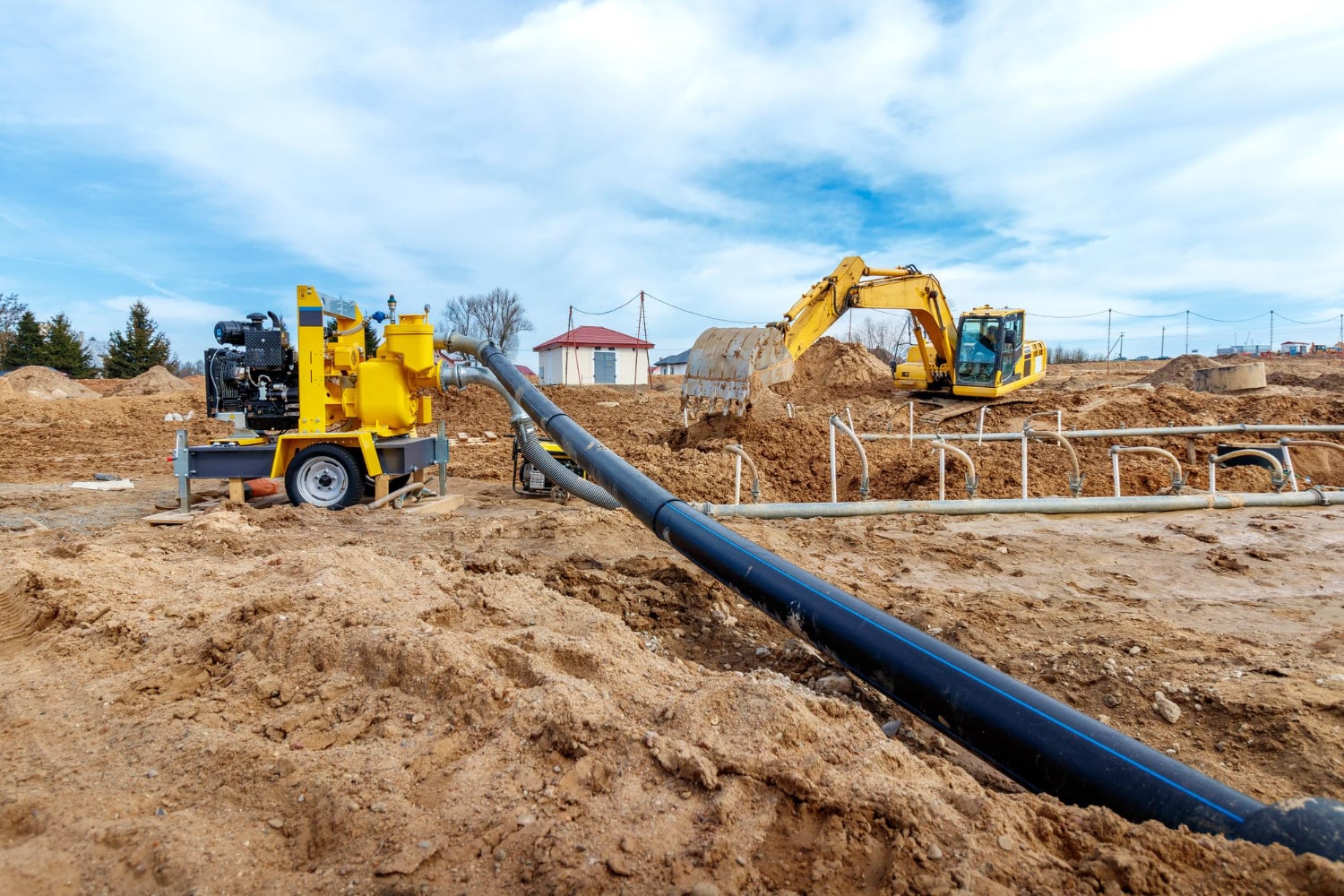 excavator-dig-trenches-construction-site-trench-laying-external-sewer-pipes-sewage-drainage-system-multistory-building-digging-pit-foundation-min